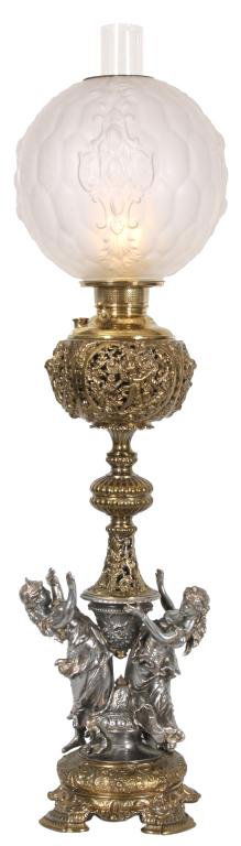 Figural Piano Lamp: Figural Piano Lamp. 2 tone base has a pair of figural robed maidens with a silvered finish; gilt finish on the foot, stem and font with fancy reticulated design; font signed "The Juno Lamp". 10 in. di