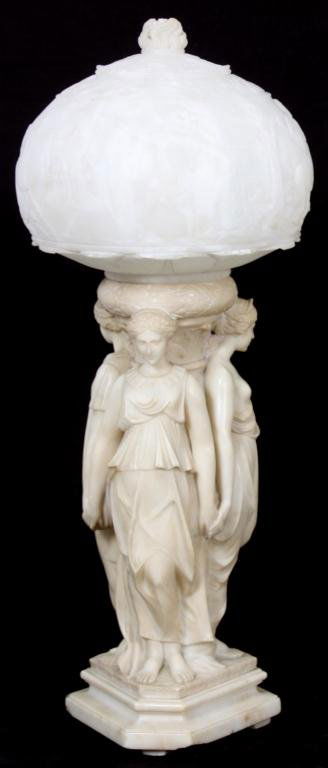 Figural Carved Italian Alabaster Lamp: Figural Carved Italian Alabaster Lamp. 3 cream colored alabaster female figures standing around the lamp post, back to back and holding hands; the figures are robed with one having an exposed bust. Wh