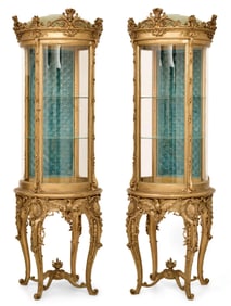A Fine Pair of American Rococo Revival Carved Giltwood Curio Cabinets
