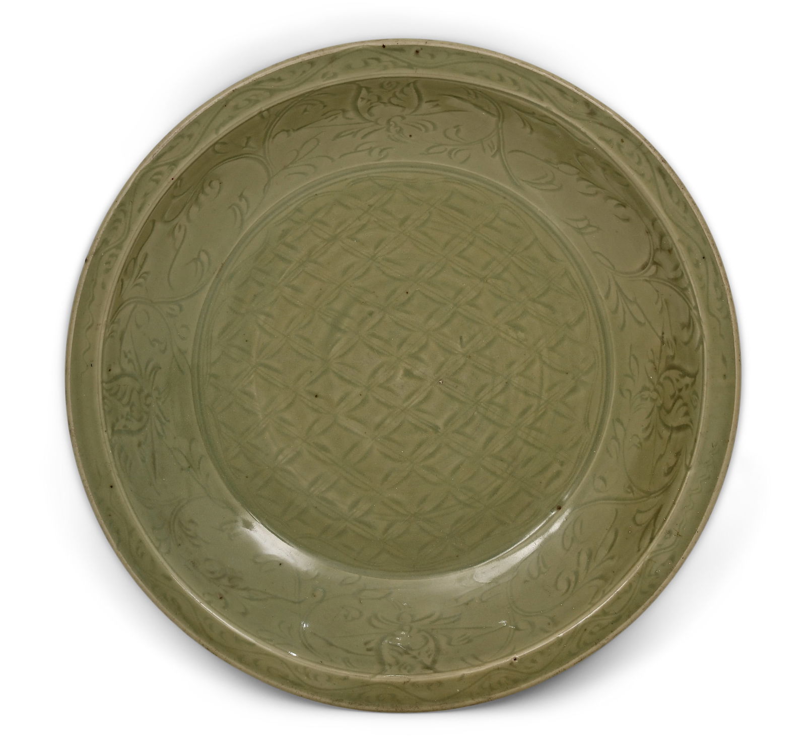 A Large Carved "Longquan" Celadon-Glazed Charger, Ming Dynasty, 15th Century: A Large Carved "Longquan" Celadon-Glazed Charger, Ming Dynasty15th centurythe dish is superbly potted with wide flaring sides rising from a flat base, the interior finely carved with a dense diaper pa