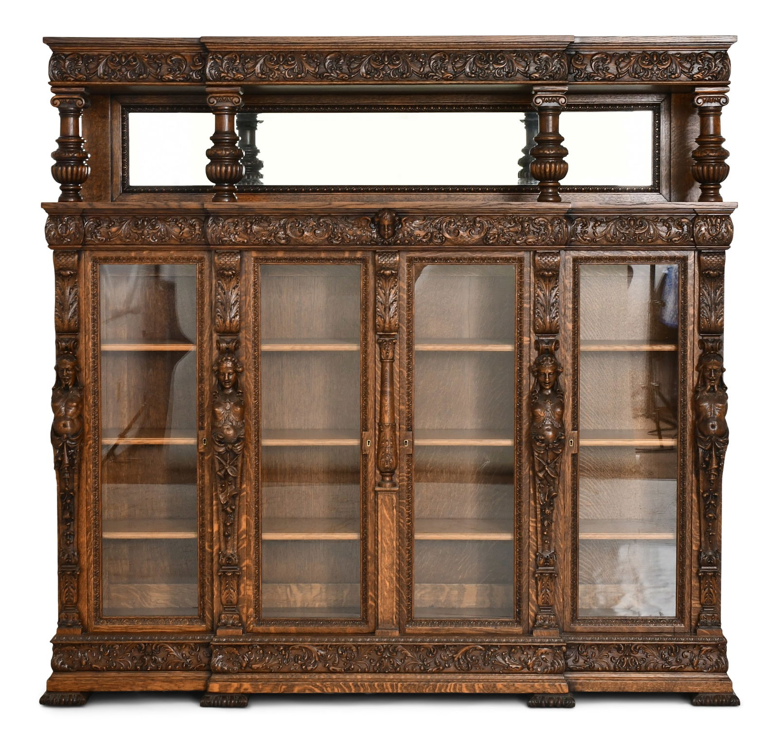 R.J. Horner & Co. Figural Four-Door Bookcase: R.J. Horner & Co.(New York, 1886-1915)Figural Four-Door Bookcasecirca 1890quarter sawn oak, glasssigned with celluloid tag77 x 82 x 18 inchesProvenance: Private Collection, Boston, Massachus