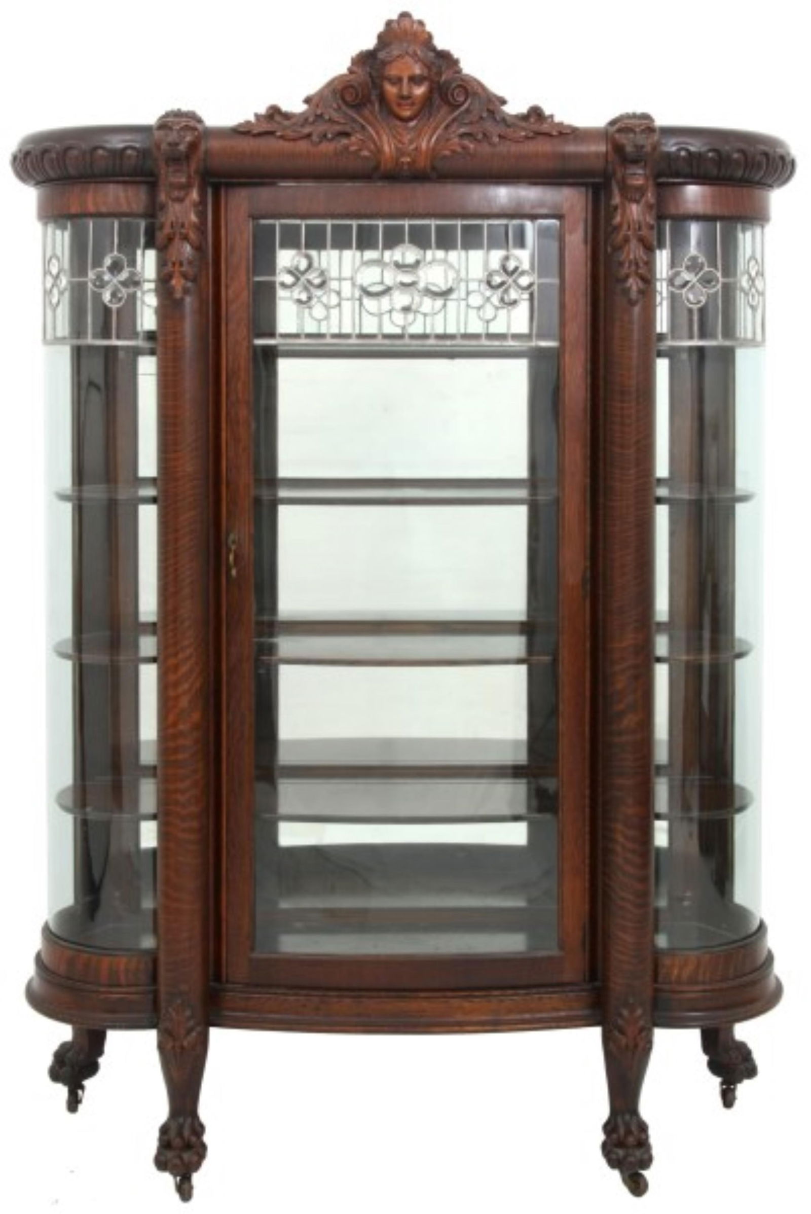 American Oak & Leaded Glass Bow-Front China Cabinet: American Oak & Leaded Glass Bow-Front China Cabinetlate 19th centurywith a maidenís head crest and lion heads over large turned quartersawn oak columns, standing on claw feet81 x 57 x 21 inchesPr
