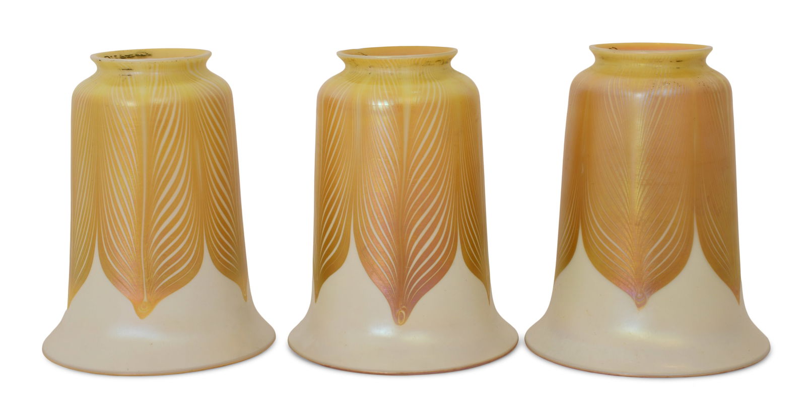 Three Quezal Art Glass "Pulled Feather" Shades: Quezal Art Glass and Decorating Company (New York, 1901-1924) Three "Pulled Feather" Shades circa 1915 iridescent glass each marked "Quezal" 5 1/2 x 4 1/2 inches Other Notes: Fontaine's Auction