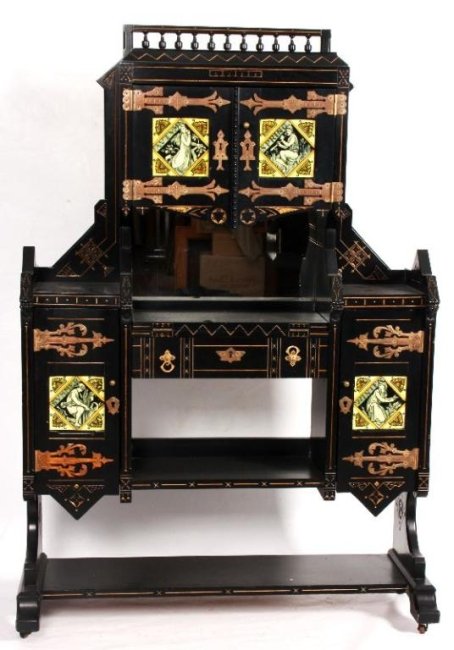 KIMBEL & CABUS HALL CABINET W/ SIMPSON & SONS TILE: The ebonized desk features gilt incised carvings with large brass strap hinges, pulls and escutcheons. The top shows a spindled gallery over 2 doors, below is a mirrored back and the fold out writing 