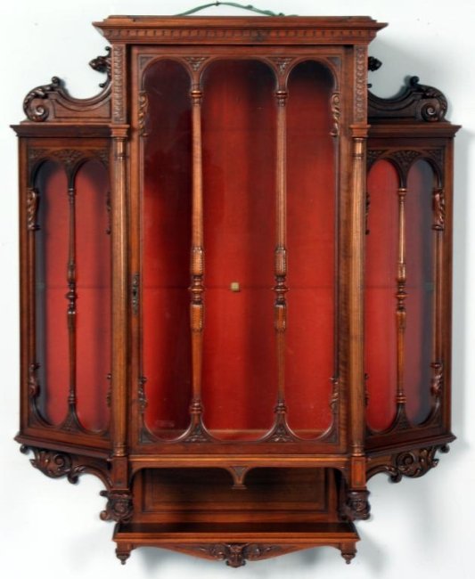 Figural Carved Walnut Wall Cabinet: Figural Carved Walnut Wall Cabinet. Fine Carved borders, turned half column mullions, lion's head and scrolled carved side crests, lower gallery with shelf and figural heads on the front posts. Large 