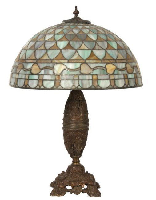 20 in. Acorn Leaded Table Lamp: 20 in. Acorn Leaded Table Lamp. Large domical shade has a green and caramel slag fish scale background and a wavy golden acorn and vine border; 4 in. aperture, 9 in. high & 20 in. dia. On a cast white