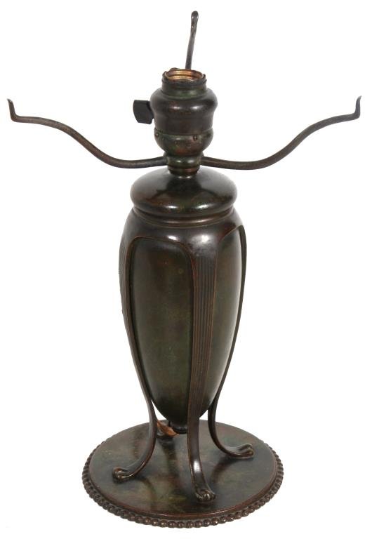Tiffany Studios Bronze Urn Lamp Base: Tiffany Studios Bronze Urn Lamp Base. Teardrop urn style base with 4 legs continuing down the side and curved at the bottom on paw feet; stands on a round platform with beaded edge and a domical top w