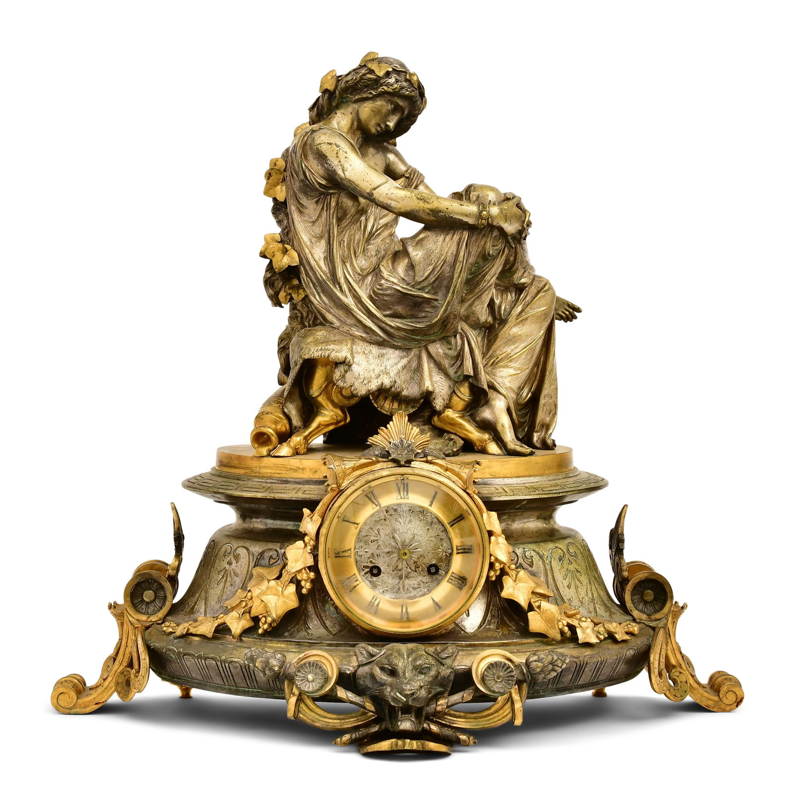French Gilt & Silvered Bronze Mantel Clock, Charpentier & Co.: French Gilt & Silvered Bronze Mantel Clock, Charpentier & Co.circa 1880surmounted by Sappho seated on a lion's pelt and elaborately decorated with leaves, berries, Greek Key borders and a lion's head,