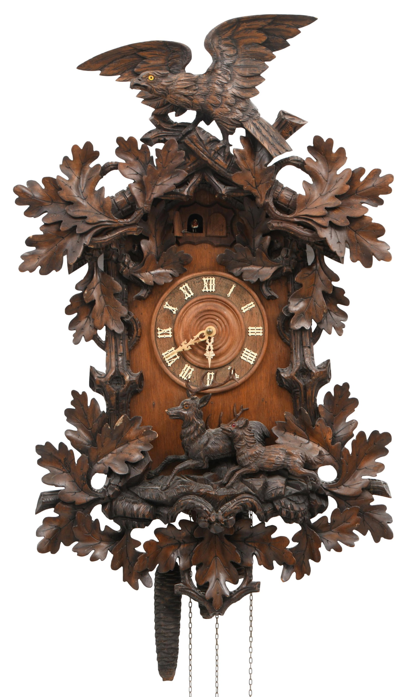 Black Forest Carved Cuckoo Clock: Black Forest Carved Cuckoo ClockGermany, late 19th centurythe case surmounted by an eagle above leaves, branches and two deer, brass 30-hour triple fusee cuckoo and quail movement, partial label on ba