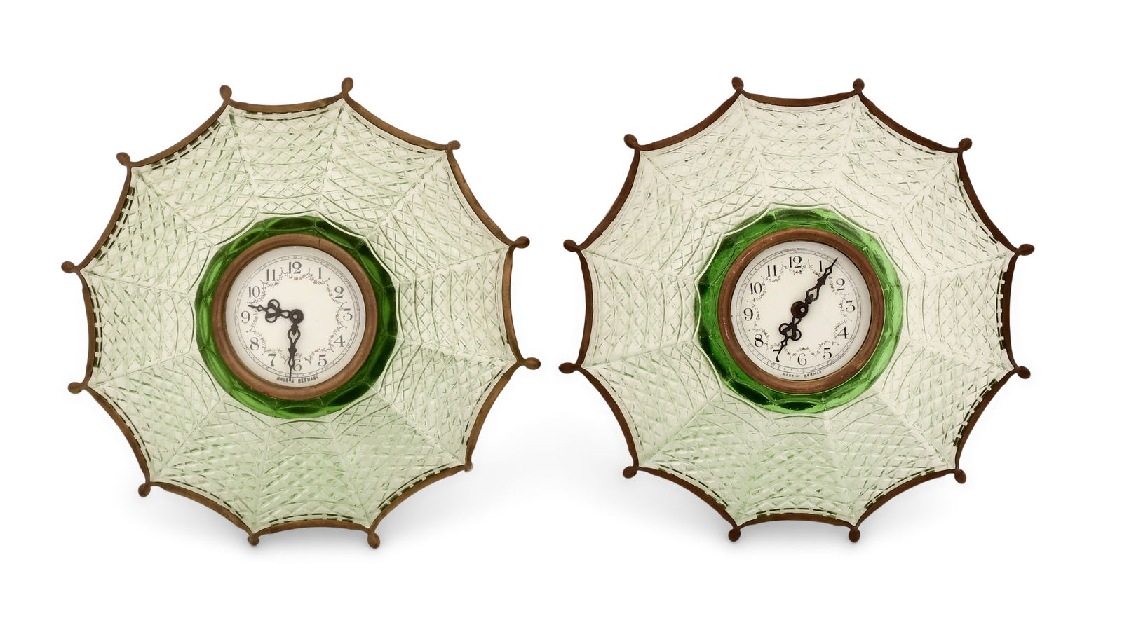 Two Green Glass Umbrella Clocks: Two Green Glass Umbrella Clocks20th centurygreen glass with brass frame and umbrella handle stand, 30-hour time only spring driven movements with pin lever escapements, both signed "Made in Germany" o