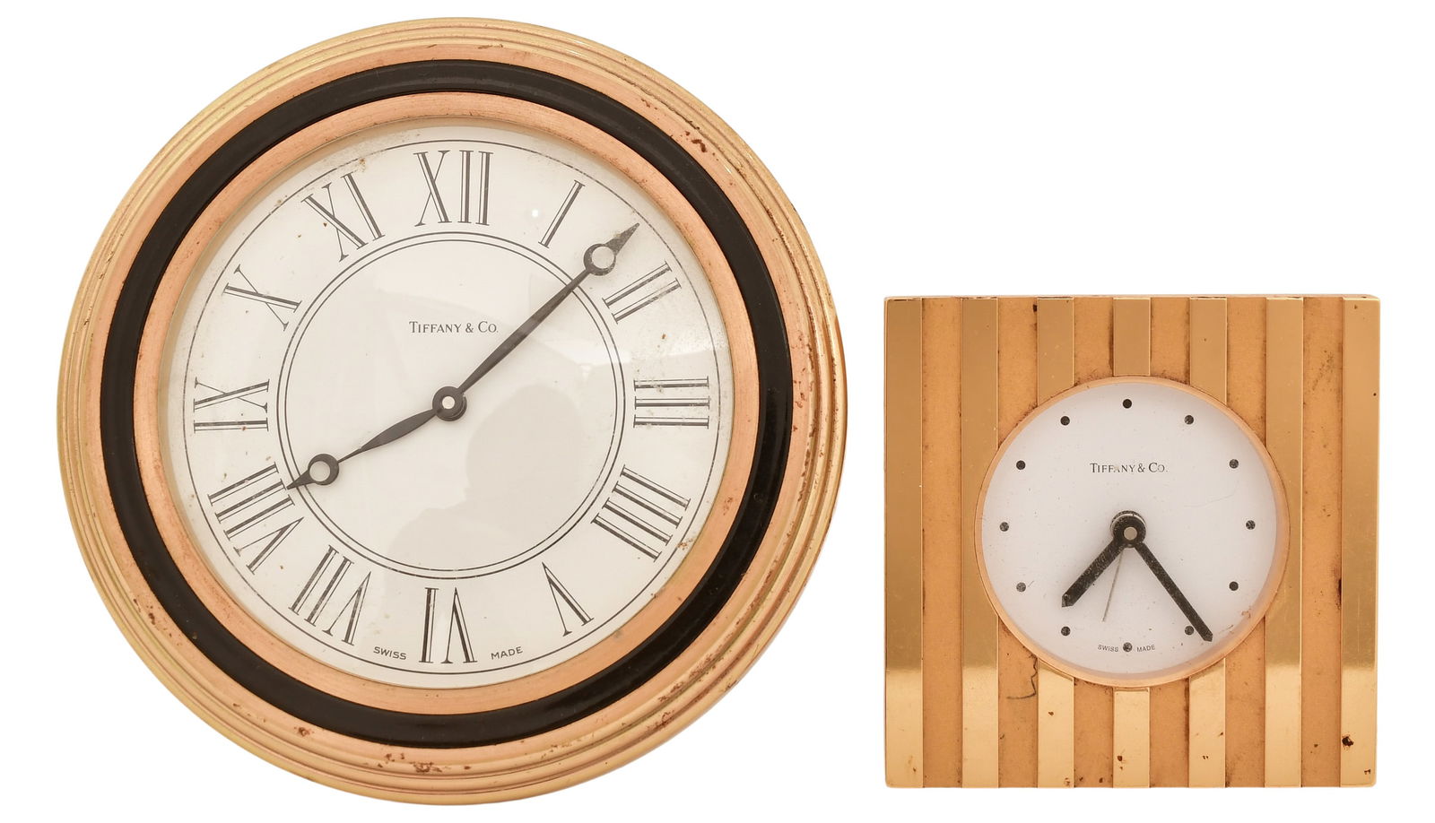 Two Tiffany & Co. Desk Clocks: Two Tiffany & Co. Desk Clocks20th centurybrass cases with battery operated movements, smaller clock is alarm, each signed4 1/2 inches (large)2 3/4 x 2 3/4 inches (small)Provenance: Private Collection,