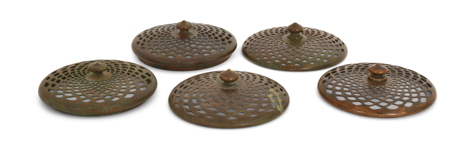 Tiffany Studios, Two Slip Heat Caps & Three Heat Caps: Tiffany Studios Two Slip Heat Caps & Three Heat Caps circa 1910 patinated bronze 3 3/4 in. diameter Provenance: Important Private Collection Other Notes: Fontaine's Auction Gallery can arrange