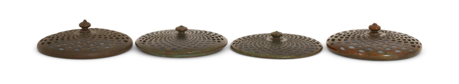Tiffany Studios, One Slip Heat Cap & Three Heat Caps: Tiffany Studios One Slip Heat Cap & Three Heat Caps circa 1910 patinated bronze 4 3/4 in. diameter Provenance: Important Private Collection Other Notes: Fontaine's Auction Gallery can arrange