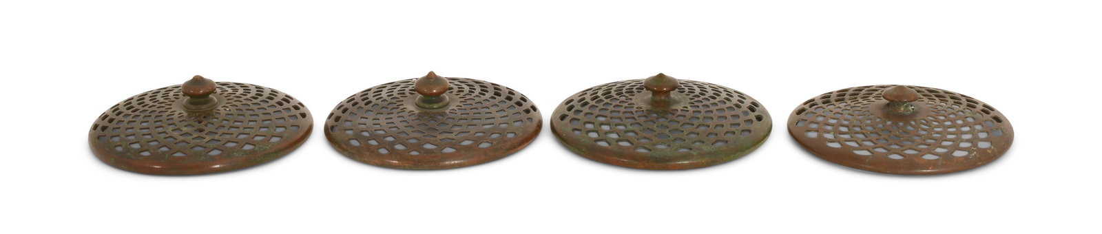Tiffany Studios, Four Heat Caps: Tiffany Studios Four Heat Caps circa 1910 patinated bronze 3 3/4 in. diameter Provenance: Important Private Collection Other Notes: Fontaine's Auction Gallery can arrange shipping for this item (USA