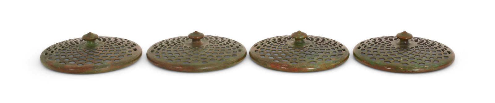 Tiffany Studios, Four Heat Caps: Tiffany Studios Four Heat Caps circa 1910 patinated bronze 3 3/4 in. diameter Provenance: Important Private Collection Other Notes: Fontaine's Auction Gallery can arrange shipping for this item (USA