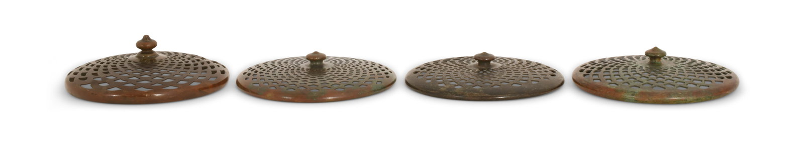 Tiffany Studios, Four Heat Caps: Tiffany Studios Four Heat Caps circa 1910 patinated bronze 4 3/4 in. diameter Provenance: Important Private Collection Other Notes: Fontaine's Auction Gallery can arrange shipping for this item (USA