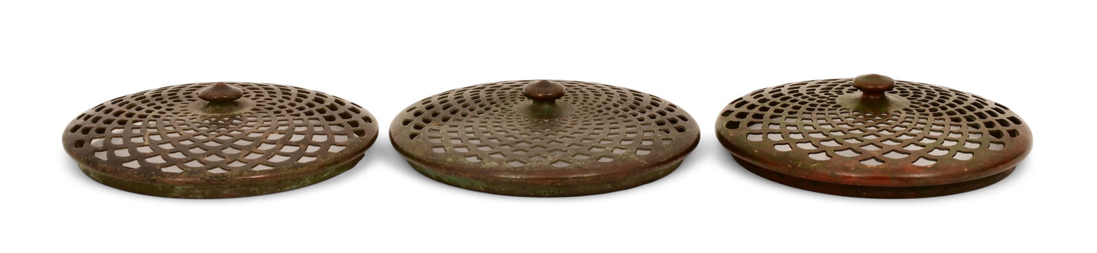 Tiffany Studios, Three Slip Heat Caps: Tiffany Studios Three Slip Heat Caps circa 1910 patinated bronze 4 3/4 in. diameter Provenance: Property from an Important Northeast Collection Other Notes: Fontaine's Auction Gallery can arrange ship
