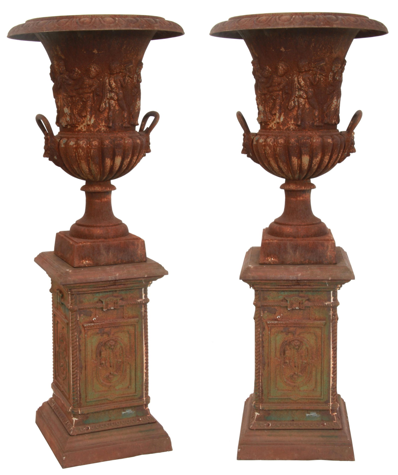 A Pair of Cast Iron Garden Urns on Pedestals: A Pair of Cast Iron Garden Urns on Pedestals 19th/20th century large cast iron urn form with relief decorated figures around the body, open loop side handles over lion's heads, turned stems and square