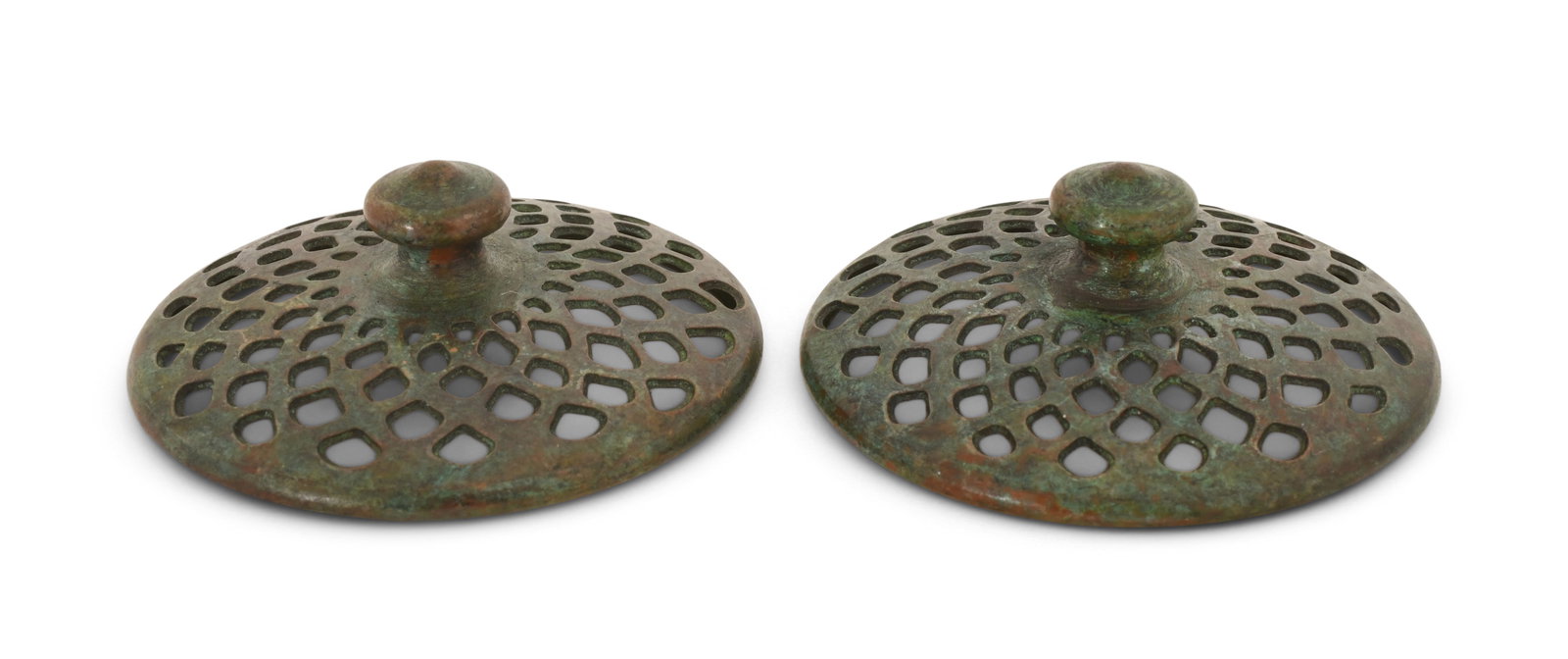 Tiffany Studios, Two Heat Caps: Tiffany Studios Two Heat Caps circa 1910 patinated bronze 2 3/8 in. diameter Provenance: Important Private Collection Other Notes: Fontaine's Auction Gallery can arrange shipping for this item (USA