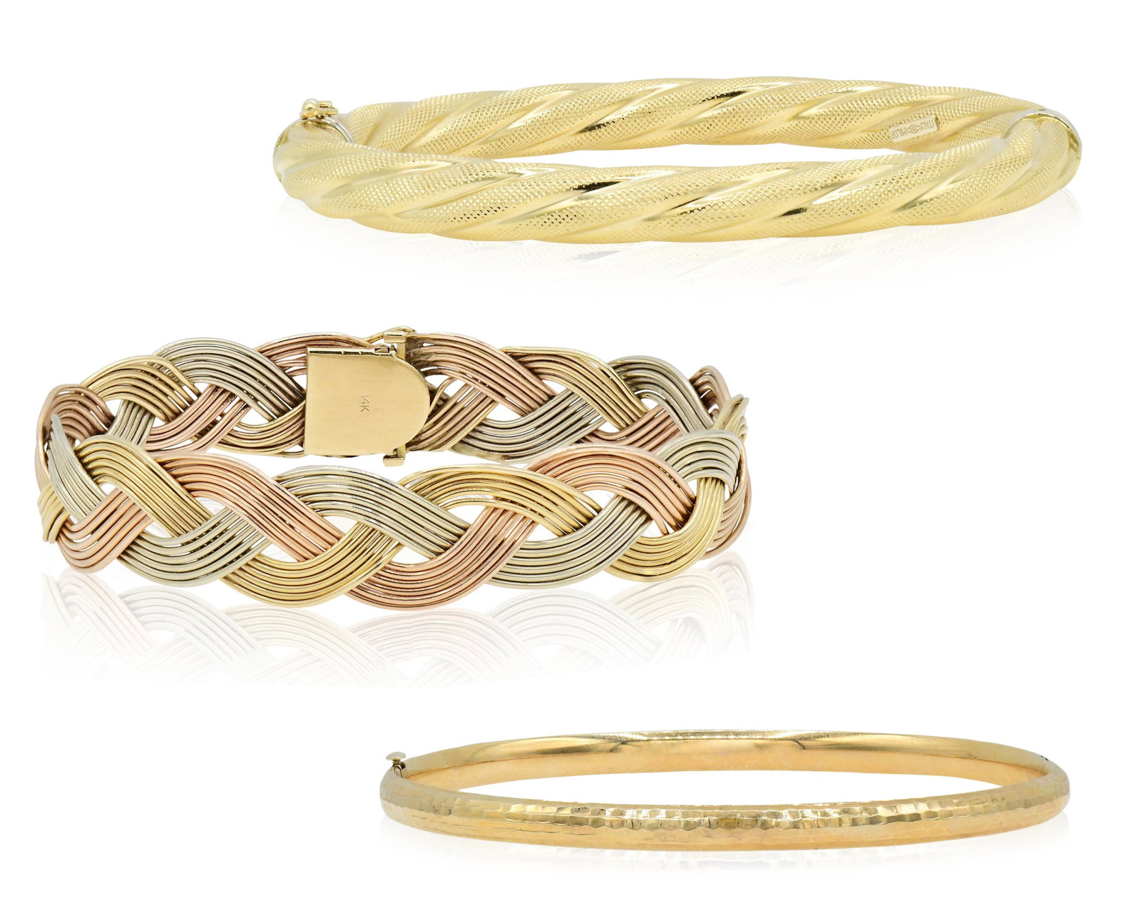 Group of Three Gold Bangle Bracelets: Group of Three Gold Bangle Bracelets • 18K yellow gold Italian bracelet, 7 3/4 inches (internal circumference) • 14K yellow gold Costa Rican bracelet, 7 1/2 inches (internal circumference)
