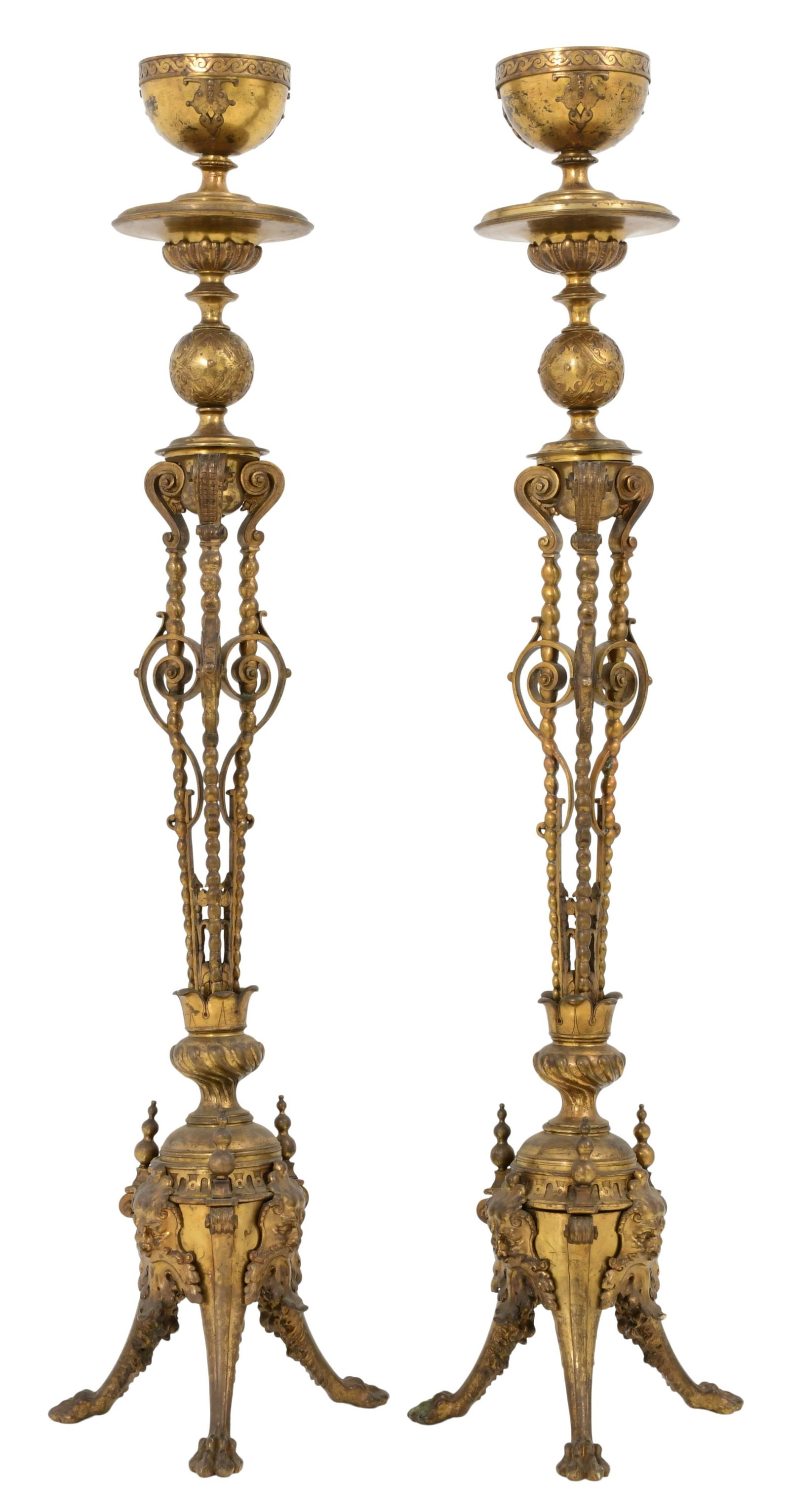 A Pair of French Gilt Bronze Torchieres: A Pair of French Gilt Bronze Torchieres circa 1875 each decorated with scrollwork and mythical heads, raised on three claw feet 60 x 16 x 14 inches