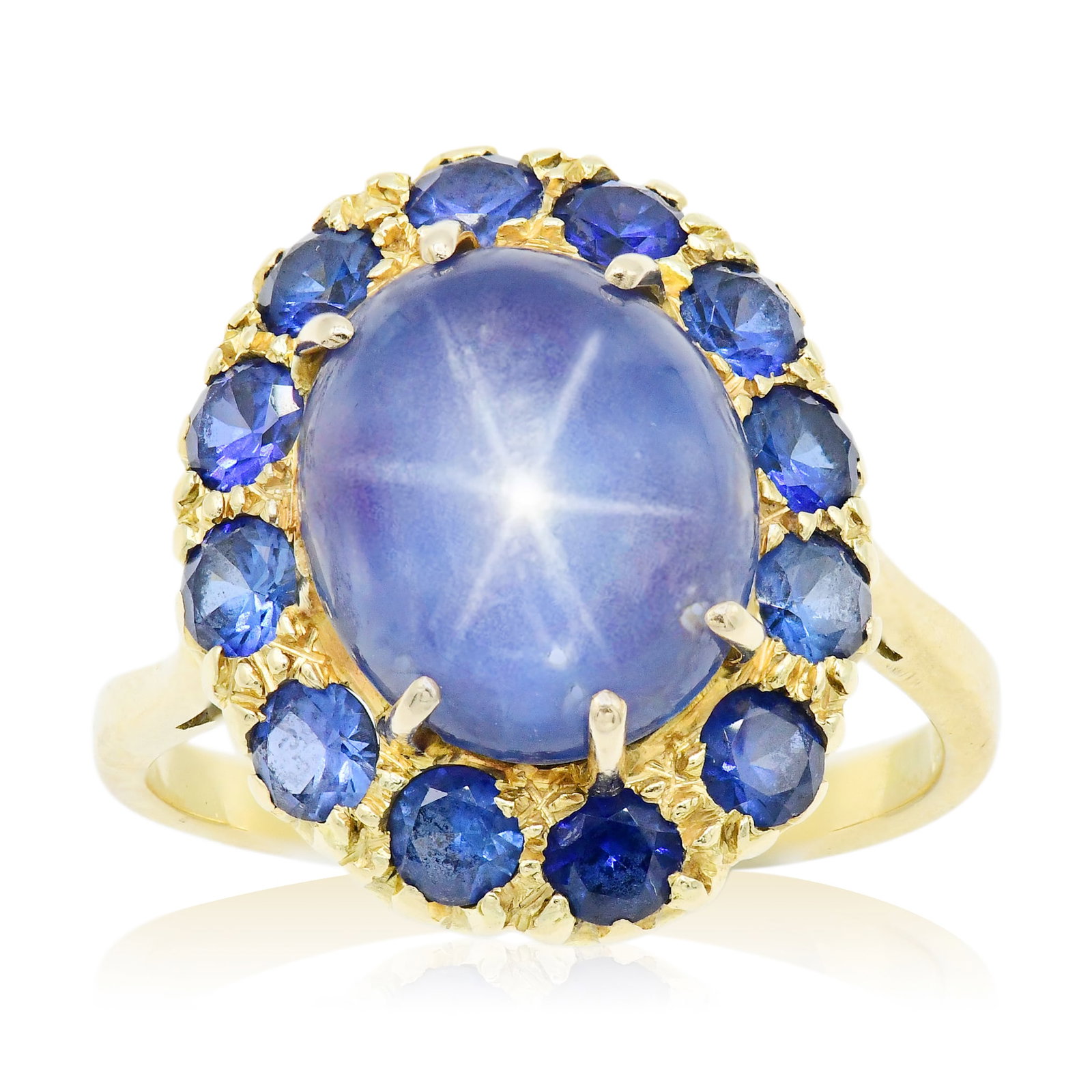 18K Yellow Gold, Star Sapphire & Sapphire Ring: 18K Yellow Gold, Star Sapphire & Sapphire Ring • featuring a 6.69 carat, natural and untreated Ceylon star sapphire • accented by faceted round sapphires weighing a total of 1.56 carats