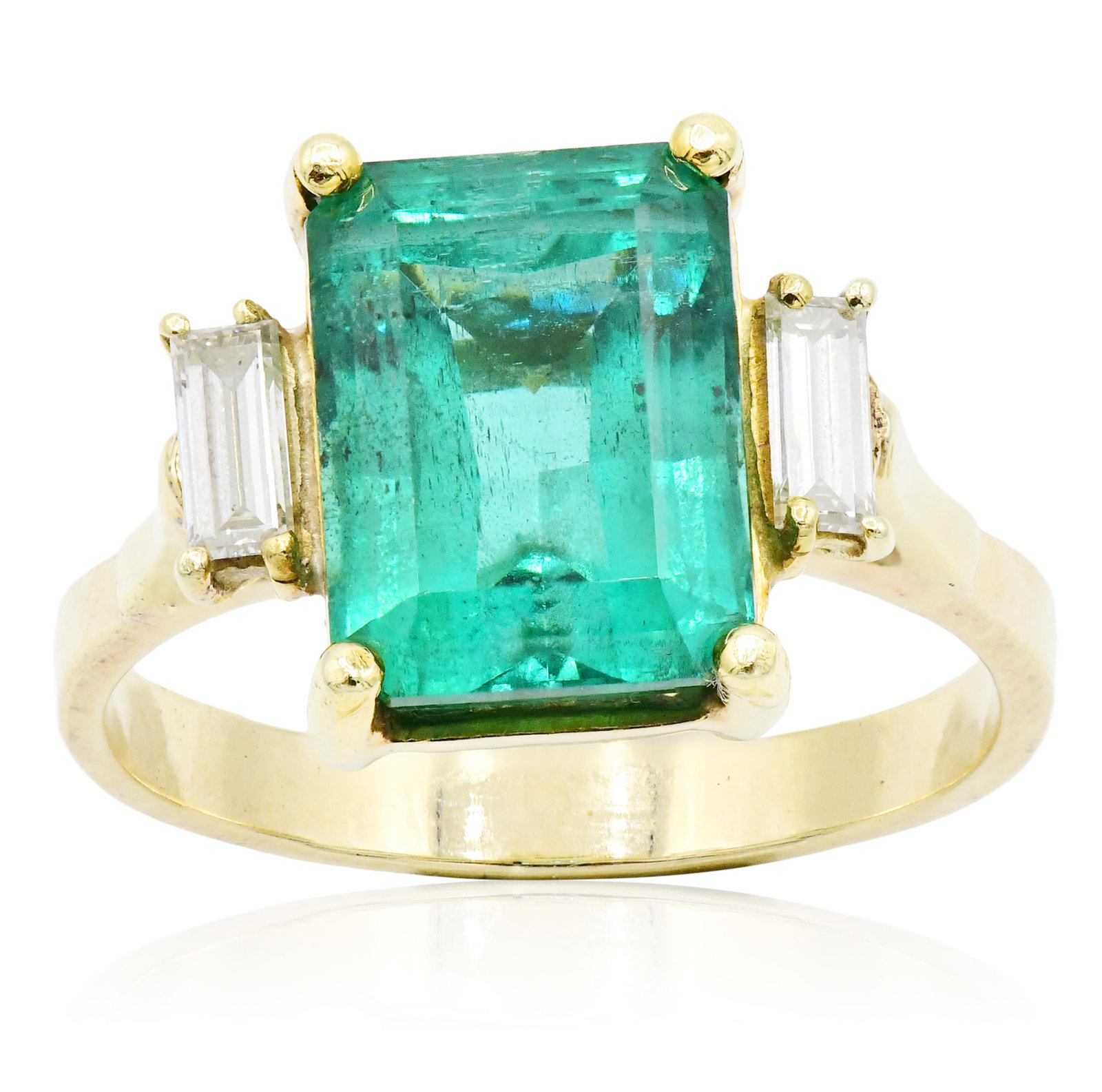 18K Yellow Gold, Emerald & Diamond Ring: 18K Yellow Gold, Emerald & Diamond Ring • featuring a 6.55 carat emerald cut emerald • accented by baguette diamonds weighing a total of 0.35 carats • 10 1/4 (ring size) • 4.5 