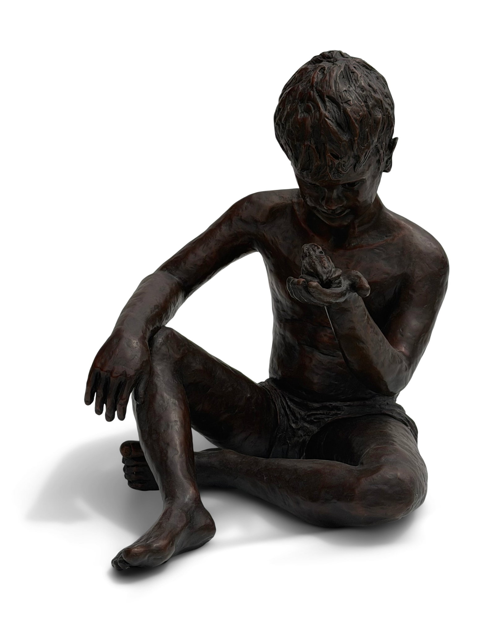 A Patinated Bronze Sculpture of a Boy Holding a Frog: A Patinated Bronze Sculpture of a Boy Holding a Frog 20th century signed and numbered Sabo, 12/15" 23 x 16 x 23 inches Provenance: Private Collection, Connecticut