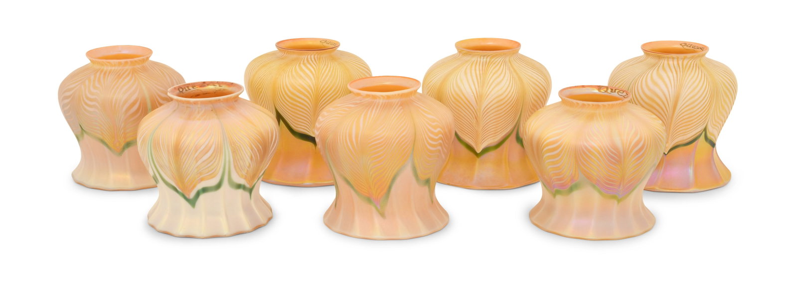Set of Seven Quezal Art Glass "Pulled Feather" Shades: Quezal Art Glass and Decorating Company (New York, 1901-1924) Set of Seven "Pulled Feather" Shades circa 1915 iridescent glass each marked "Quezal" 4 x 4 1/2 inches Provenance: Private Collection,