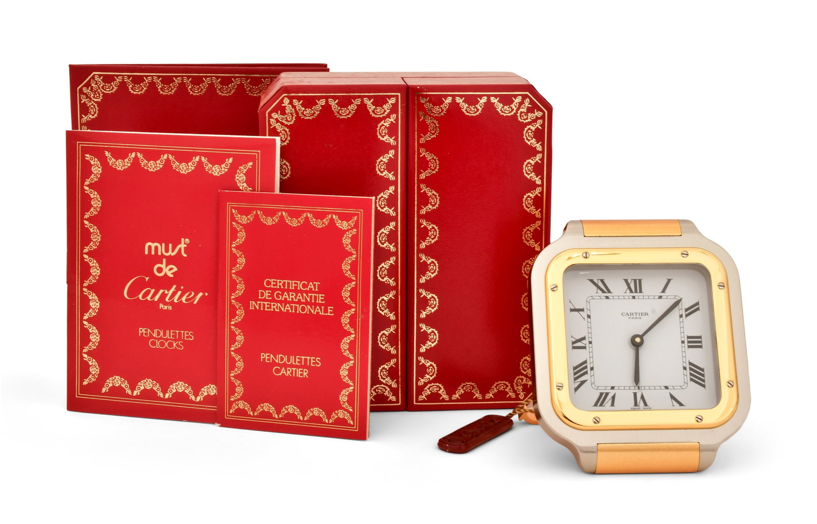 Cartier "Must de Cartier" Travel Alarm Clock: Cartier "Must de Cartier" Travel Alarm Clock 20th century stainless steel, lacquered metal and gold-plated metal, with box 3 1/2 x 3 inches (clock) 5 1/4 x 4 1/2 x 2 3/4 inches (box) Other Notes: Font