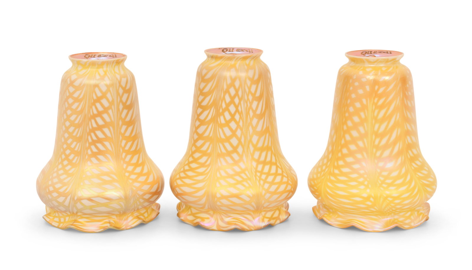 Set of Three Quezal Art Glass Decorated Shades: Quezal Art Glass and Decorating Company (New York, 1901-1924) Set of Three Decorated Shades circa 1915 iridescent glass each marked "Quezal" 6 x 5 inches Provenance: Private Collection, Tennessee