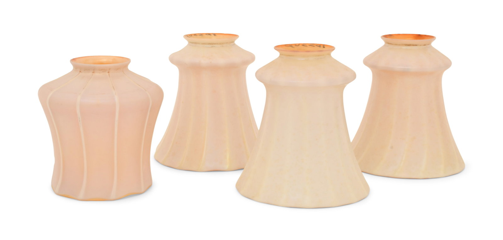 Four Quezal Art Glass Ribbed Shades: Quezal Art Glass and Decorating Company (New York, 1901-1924) Four Ribbed Shades circa 1915 iridescent glass each marked "Quezal" 4 1/2 x 4 inches Provenance: Private Collection, Tennessee