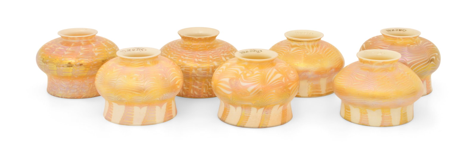 Set of Seven Quezal Art Glass Decorated Shades: Quezal Art Glass and Decorating Company (New York, 1901-1924) Set of Seven Decorated Shades circa 1915 iridescent glass each marked "Quezal" 3 x 5 inches Provenance: Private Collection, Tennessee