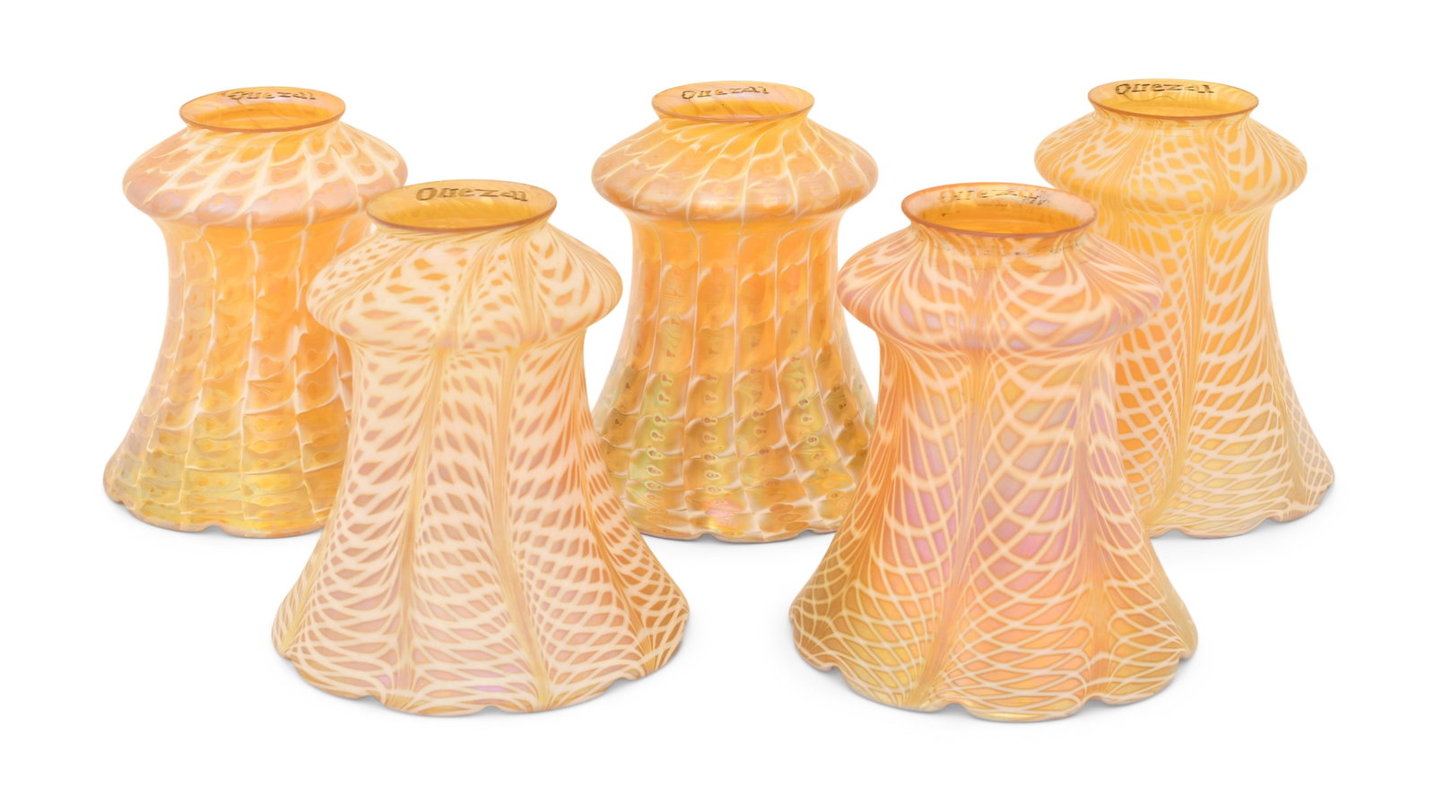 Five Quezal Art Glass Decorated Shades: Quezal Art Glass and Decorating Company (New York, 1901-1924) Five Decorated Shades circa 1915 iridescent glass each marked "Quezal" 5 x 5 inches Provenance: Private Collection, Tennessee