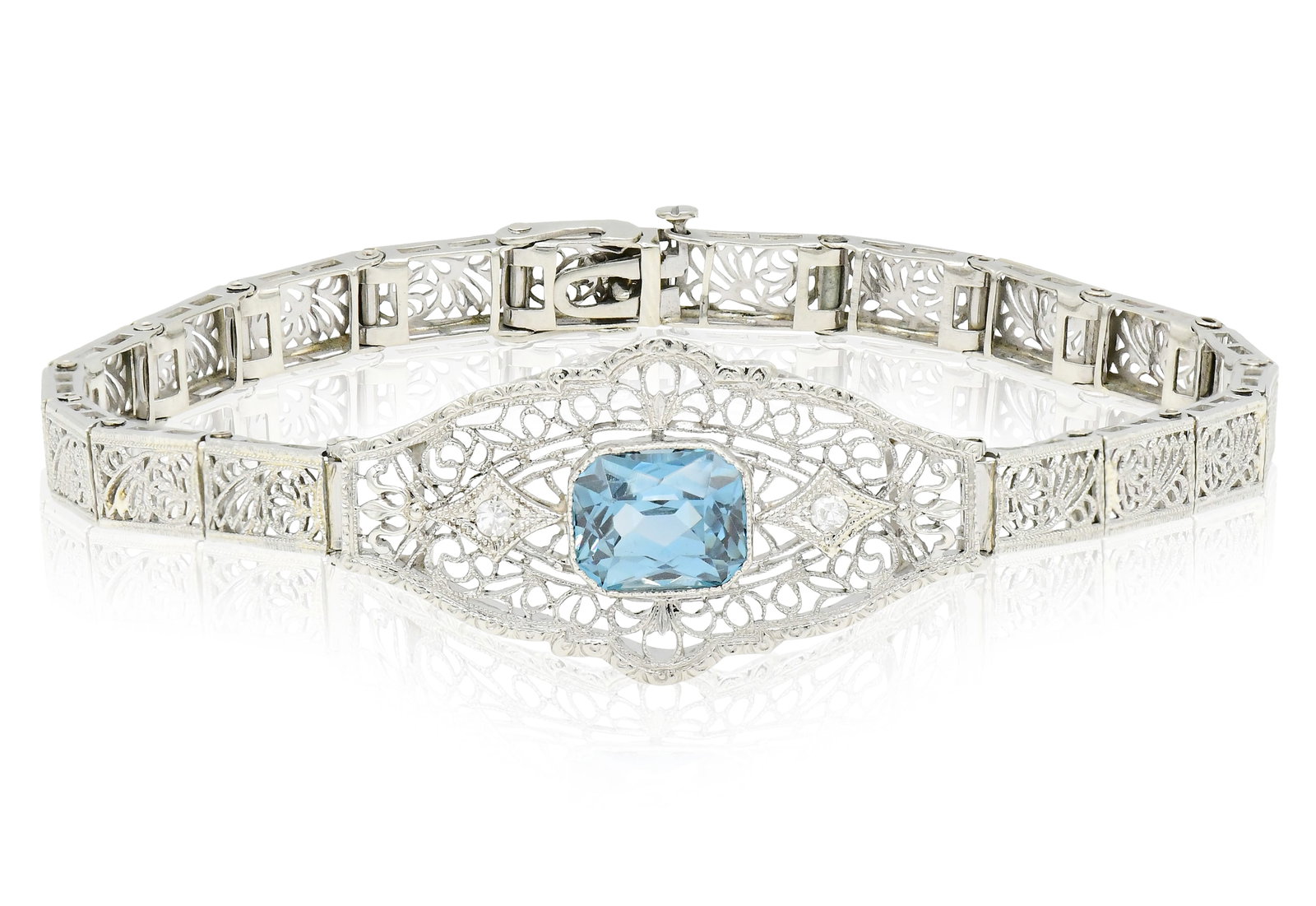 14K White Gold, Blue Topaz & Diamond Art Deco Bracelet: 14K White Gold, Blue Topaz & Diamond Art Deco Bracelet • featuring a 2.27 carat emerald cut blue topaz • accented by single cut diamonds weighing a total of 0.04 carats • 6 15/16 inc