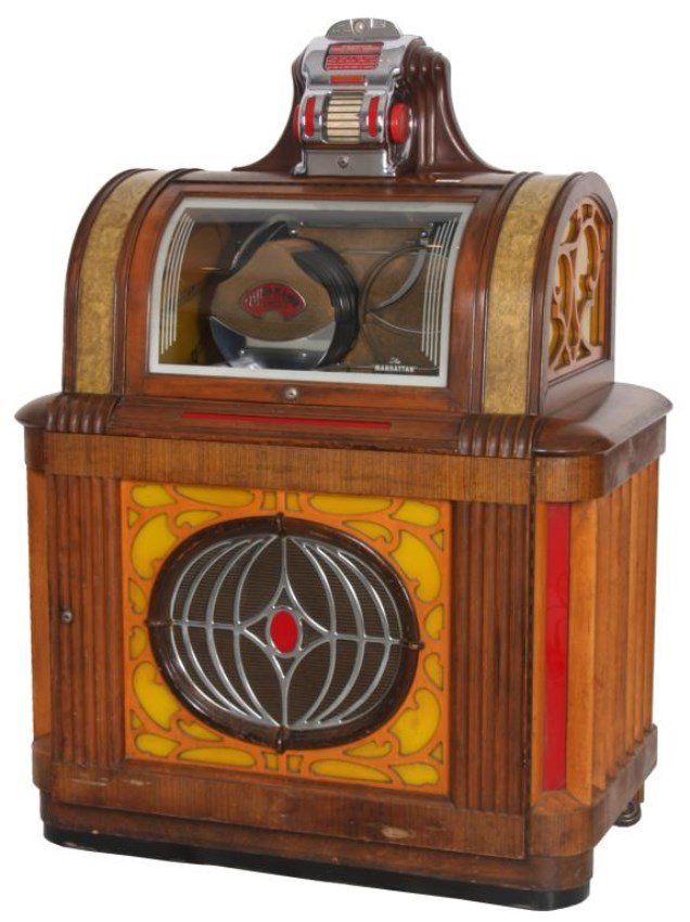 Packard Manhattan Model Jukebox – 1946: Packard Manhattan Model Jukebox – 1946. Deluxe full sized juke box produced by Senator Homer E. Capehart, case has 2 tone wood veneers, a curved front lid with etched viewing glass exposing the sele