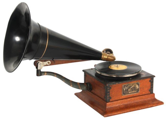 Victor Type R Disc Phonograph: Victor Type R Disc Phonograph. The square oak case has a splayed base molding with brass straps on the corners, brass support arm and oak stick tone arm; the reproducer has a brass fitting on the end 