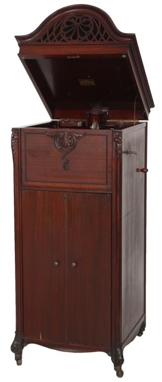 Mahogany Keen-O-Phone Phonograph: Mahogany Keen-O-Phone Phonograph. Floor standing Keen-O-Phone style XXX, mahogany case leaf carved on the corners and at the feet, has a single door in the base with 2 tier 100 disc music rack under a
