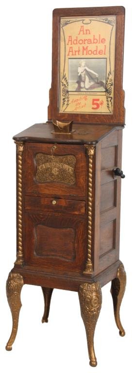 The Cail-O-Scope Oak Viewing Machine: The Cail-O-Scope Oak Viewing Machine. 5 cent coin operated machine in oak with inset panels, cast metal view finder, cabriole legs, spiral turned half columns and inset front panel with Caille Bros. C