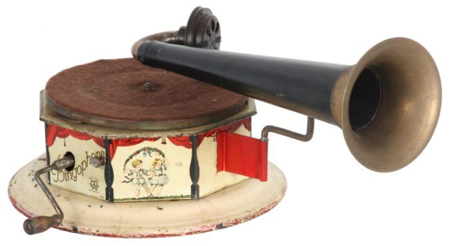 Bingophone Tin Litho Toy Phonograph: Bingophone Tin Litho Toy Phonograph. Colorful tin lithograph octagonal case, decorated on each panel with various circus performers under a red curtain with a white background and on a round domed bas