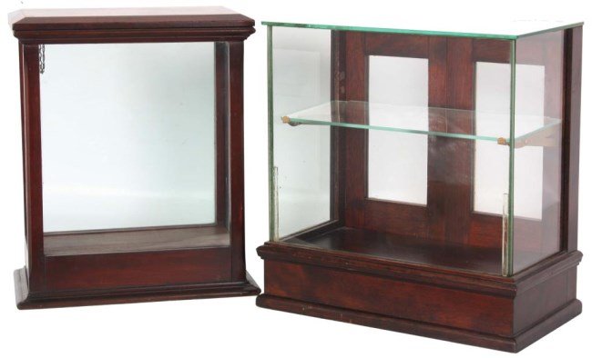 2 Store Countertop Display Cases: 2 Store Countertop Display Cases. Walnut display case has glass front, sides, top and a single shelf with 2 doors in the back with glass panels, has an original finish and is in good condition; 17.25