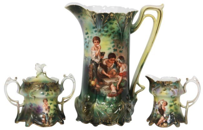 R. S. Prussia Melon Boys: R. S. Prussia Melon Boys Pitcher, Sugar & Creamer. The large pitcher has an open top with long pierced handle, decorated on the front with melon eater boy standing beside 2 children playing dice; on a