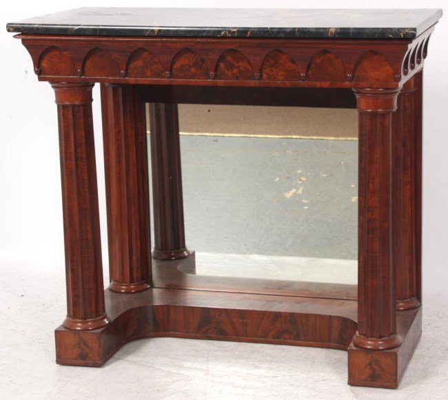 Mahogany Marble Top Pier Table: Mahogany Marble Top Pier Table. Black marble top with carved gothic arched apron with inverted acorn turnings at the points; large turned and fluted column supports in the front and half columns on ei