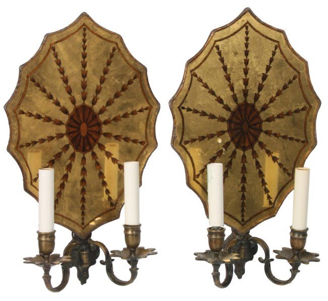 Pr. 2 Arm Wall Sconces: Pr. 2 Arm Wall Sconces. Reverse decorated glass back panel has a Sheraton style medallion and bell flower design on a mirrored gilt background, a wood paneled back with hand tooled brass trim around t
