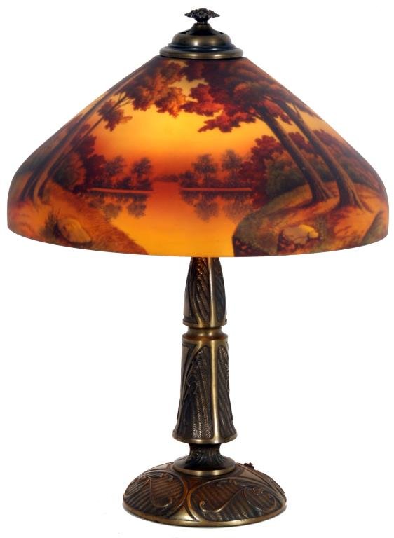 18 in. Phoenix Reverse Painted Table Lamp: 18 in. Phoenix Reverse Painted Table Lamp. Beautiful reverse painted sunset lake scene with large trees along the shoreline in the foreground and colorful early autumn trees lining the shores in the b