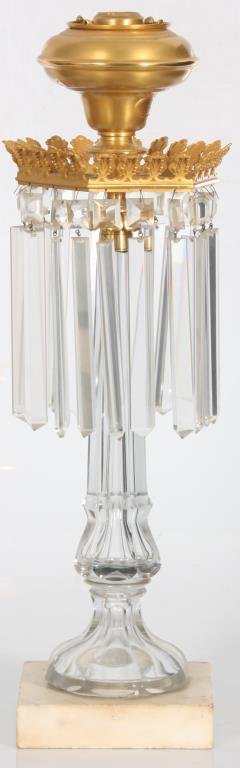 Cut Glass & Marble Sinumbra Lamp: Cut Glass & Marble Sinumbra Lamp. Gilt brass font with hexagonal leaf decorated shoulder having a series of hanging prisms; the long cut glass stem tapers down and is trumpeted at the bottom, in a whi