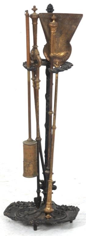 5 Pc. Brass & Cast Iron Fireplace Tool Set: 5 Pc. Brass & Cast Iron Fireplace Tool Set. Black painted cast iron stand has an oval base plate with filigree design, long stem with leafy handle on top and wreath decorated support; the 4 tools are 