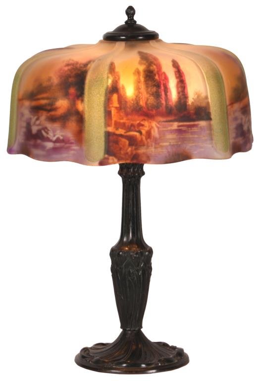 16 in. Pittsburgh Reverse Painted Table Lamp: 16 in. Pittsburgh Reverse Painted Table Lamp. 6 reverse painted scenic panels with tall fir trees along a pond scene with swimming swans, divided by obverse frosted vertical ribs with green highlights