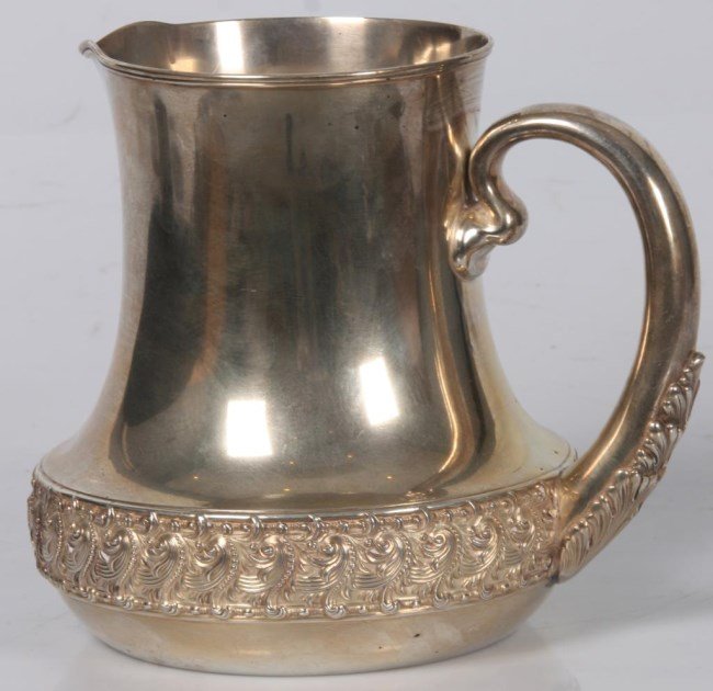 Tiffany & Co Makers Sterling Pitcher: Tiffany & Co Makers Sterling Pitcher. 5 Pint sterling silver pitcher has a D-shaped handle with acanthus leaf design at the base and is decorated with a heavy wave pattern border at the base. Signed T