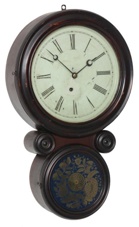 Ingraham “Ionic” Hanging Wall Clock: Ingraham “Ionic” Hanging Wall Clock. 10 in. painted metal dial has black Roman hour numerals and blued open moon hands; brass 8 day spring driven time only movement has a brass covered pendulum bo